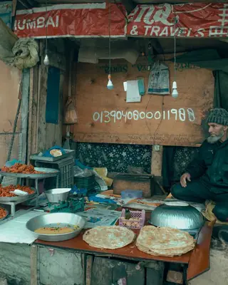A Mumbai corner shop painted in faded blue and yellow